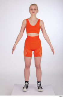 Unaisa a-pose dressed orange bike shorts orange sports bra standing…